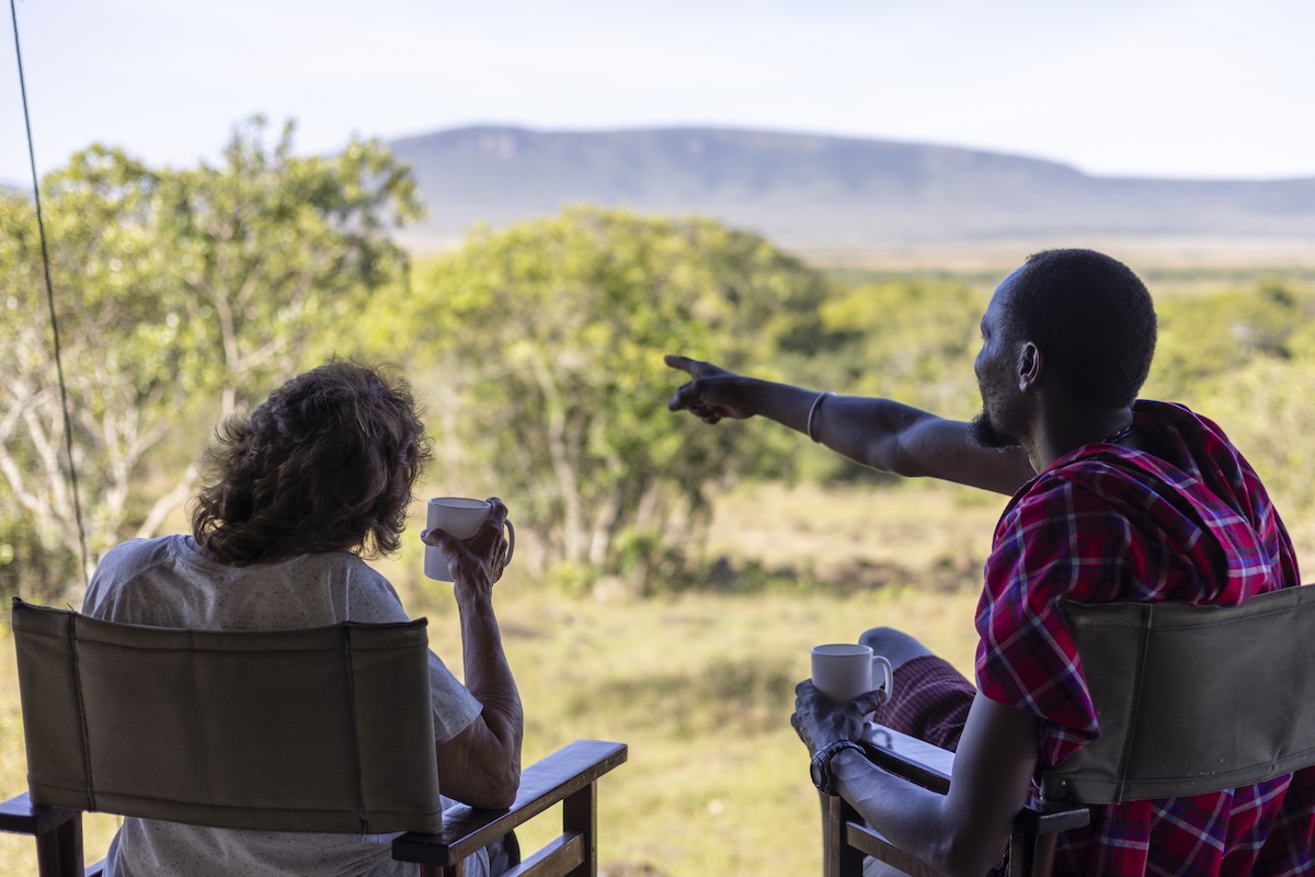 Maasai guide and tourist watching the savannah from Mattikoko Safari Camp, Maasai Mara